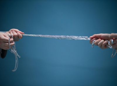 Close-up of hands gripping a pull-up bar, demonstrating focus.