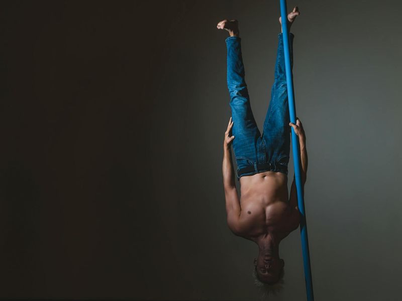 Man in a dynamic movement pose, showing strength and balance.